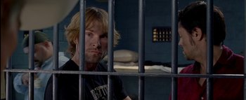 Movie still from “The Dukes of Hazzard” (2005), directed by Jay Chandrasekhar – A man sitting behind bars in a jail cell; Close Up shot, Over the shoulder angle