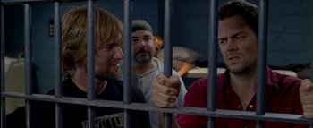 Movie still from “The Dukes of Hazzard” (2005), directed by Jay Chandrasekhar – A group of men standing next to each other in front of a jail cell; Medium shot, Over the shoulder angle