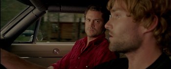 Movie still from “The Dukes of Hazzard” (2005), directed by Jay Chandrasekhar – Two men sitting in the back seat of a car; Close Up shot, Over the shoulder angle