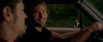 Movie still from “The Dukes of Hazzard” (2005), directed by Jay Chandrasekhar – A man sitting in the driver's seat of a car; Close Up shot, Over the shoulder angle