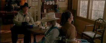 Movie still from “The Dukes of Hazzard” (2005), directed by Jay Chandrasekhar – Two women sitting at a table with a rope around their neck; Medium shot, Over the shoulder angle