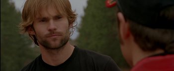 Movie still from “The Dukes of Hazzard” (2005), directed by Jay Chandrasekhar – A person wearing a black t - shirt; Close Up shot, Over the shoulder angle