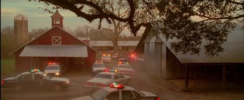 Movie still from “The Dukes of Hazzard” (2005), directed by Jay Chandrasekhar – A line of police cars driving down a street; Extreme Wide shot, High angle