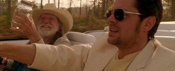 Movie still from “The Dukes of Hazzard” (2005), directed by Jay Chandrasekhar – A man and a woman riding in the back of a car; Close Up shot, Low angle