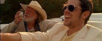 Movie still from “The Dukes of Hazzard” (2005), directed by Jay Chandrasekhar – Two men sitting in the back seat of a car; Close Up shot, Low angle