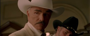 Movie still from “The Dukes of Hazzard” (2005), directed by Jay Chandrasekhar – A man in a white cowboy hat looking at the camera; Close Up shot, Low angle