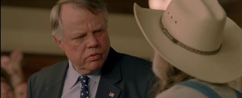 Movie still from “The Dukes of Hazzard” (2005), directed by Jay Chandrasekhar – An older man wearing a cowboy hat talking to a younger man; Close Up shot, Over the shoulder angle