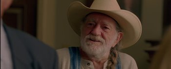 Movie still from “The Dukes of Hazzard” (2005), directed by Jay Chandrasekhar – An older man wearing a cowboy hat and vest; Close Up shot, Over the shoulder angle