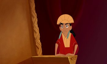 Movie still from “The Emperor's New Groove” (2000), directed by Mark Dindal – A cartoon of a person sitting in front of a mirror; Medium shot, Over the shoulder angle