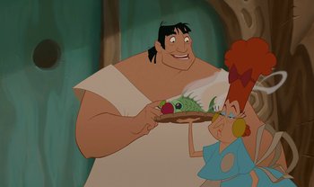 Movie still from “The Emperor's New Groove” (2000), directed by Mark Dindal – A man holding a plate of food next to a woman with red hair; Medium shot, Over the shoulder angle