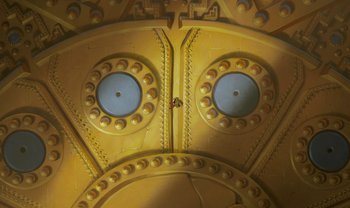 Movie still from “The Emperor's New Groove” (2000), directed by Mark Dindal – View of a yellow building with blue eyes; Extreme Wide shot, Low angle