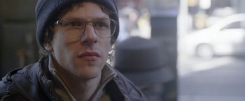 Movie still from “The End of the Tour” (2015), directed by James Ponsoldt – A person wearing glasses and a hat; Close Up shot, Over the shoulder angle