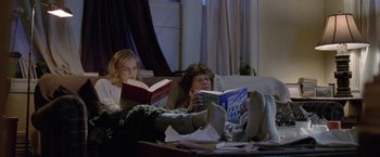 Movie still from “The End of the Tour” (2015), directed by James Ponsoldt – Two people are reading books on a couch; Wide shot, High angle