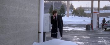 Movie still from “The End of the Tour” (2015), directed by James Ponsoldt – A man in a black coat talking on a phone; Wide shot, High angle