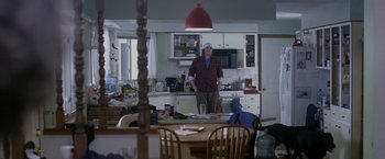 Movie still from “The End of the Tour” (2015), directed by James Ponsoldt – A man standing in a kitchen next to a table; Wide shot, Low angle