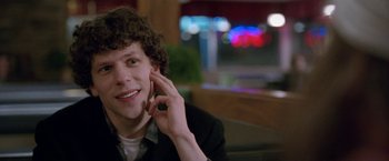 Movie still from “The End of the Tour” (2015), directed by James Ponsoldt – A man sitting at a table talking on a cell phone; Close Up shot, Over the shoulder angle