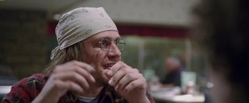 Movie still from “The End of the Tour” (2015), directed by James Ponsoldt – A man with a bandana on his head and glasses; Close Up shot, Over the shoulder angle
