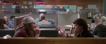 Movie still from “The End of the Tour” (2015), directed by James Ponsoldt – Two people sitting at a table in front of each other; Medium shot, Over the shoulder angle