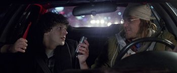 Movie still from “The End of the Tour” (2015), directed by James Ponsoldt – A man and a woman sitting in the back of a car; Close Up shot, Over the shoulder angle
