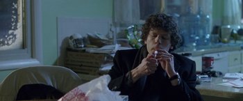 Movie still from “The End of the Tour” (2015), directed by James Ponsoldt – A person sitting at a table eating a sandwich; Medium shot, Over the shoulder angle