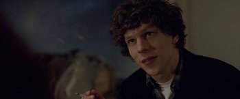 Movie still from “The End of the Tour” (2015), directed by James Ponsoldt – A man with curly hair is smoking a cigarette; Close Up shot, Over the shoulder angle