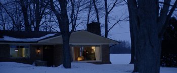 Movie still from “The End of the Tour” (2015), directed by James Ponsoldt – A person standing outside of a house in the snow; Extreme Wide shot, Low angle