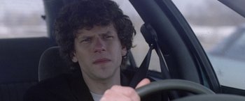 Movie still from “The End of the Tour” (2015), directed by James Ponsoldt – A man sitting in the drivers seat of a car; Close Up shot, Over the shoulder angle