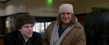 Movie still from “The End of the Tour” (2015), directed by James Ponsoldt – A man in a white hat and a man in a brown jacket; Close Up shot, Over the shoulder angle