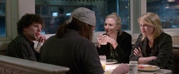 Movie still from “The End of the Tour” (2015), directed by James Ponsoldt – Two people are sitting at a table and talking to each other; Medium shot, Over the shoulder angle