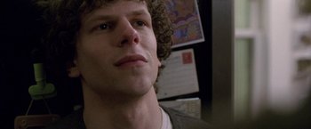 Movie still from “The End of the Tour” (2015), directed by James Ponsoldt – A person with curly brown hair; Close Up shot, Over the shoulder angle