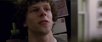 Movie still from “The End of the Tour” (2015), directed by James Ponsoldt – A person with curly brown hair; Close Up shot, Over the shoulder angle