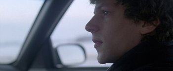 Movie still from “The End of the Tour” (2015), directed by James Ponsoldt – A person in a car looking out of the window; Close Up shot, Over the shoulder angle