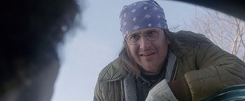 Movie still from “The End of the Tour” (2015), directed by James Ponsoldt – A person wearing glasses and a hat; Close Up shot, Over the shoulder angle