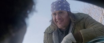 Movie still from “The End of the Tour” (2015), directed by James Ponsoldt – A person wearing glasses and a hat; Close Up shot, Over the shoulder angle