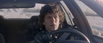 Movie still from “The End of the Tour” (2015), directed by James Ponsoldt – A man in a car driving a car; Close Up shot, Over the shoulder angle