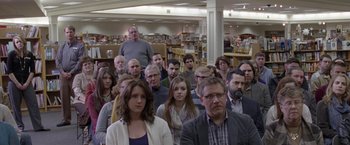 Movie still from “The End of the Tour” (2015), directed by James Ponsoldt – A group of people sitting in a room; Wide shot, Over the shoulder angle