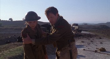 Movie still from “The English Patient” (1996), directed by Anthony Minghella – A man and a boy in military uniforms; Medium shot, Over the shoulder angle