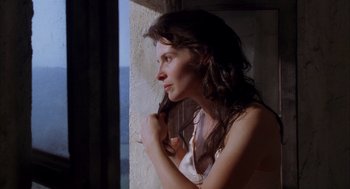 Movie still from “The English Patient” (1996), directed by Anthony Minghella – A woman looking out of a window at night; Close Up shot, Over the shoulder angle