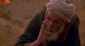 Movie still from “The English Patient” (1996), directed by Anthony Minghella – An old man with a beard wearing a turban; Close Up shot, High angle