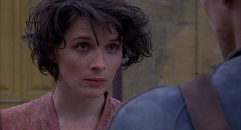 Movie still from “The English Patient” (1996), directed by Anthony Minghella – A person looking at the camera; Close Up shot, Over the shoulder angle