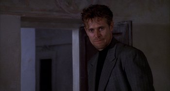 Movie still from “The English Patient” (1996), directed by Anthony Minghella – A person wearing a suit and tie; Close Up shot, Low angle