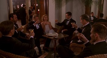 Movie still from “The English Patient” (1996), directed by Anthony Minghella – A group of people sitting around a table drinking wine; Wide shot, High angle
