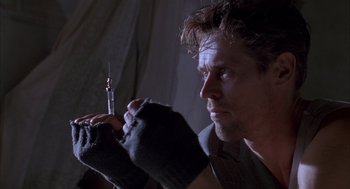 Movie still from “The English Patient” (1996), directed by Anthony Minghella – A person holding a syringe; Close Up shot, Low angle