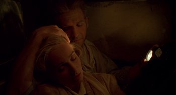 Movie still from “The English Patient” (1996), directed by Anthony Minghella – A man and a woman laying on a bed; Close Up shot, High angle