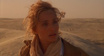 Movie still from “The English Patient” (1996), directed by Anthony Minghella – A person wearing a scarf; Close Up shot, Over the shoulder angle