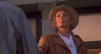 Movie still from “The English Patient” (1996), directed by Anthony Minghella – A woman wearing a hat and a brown jacket; Close Up shot, Low angle