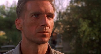 Movie still from “The English Patient” (1996), directed by Anthony Minghella – A man's face with trees in the background; Close Up shot, Low angle