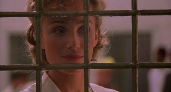 Movie still from “The English Patient” (1996), directed by Anthony Minghella – A person behind a fence; Close Up shot, Over the shoulder angle