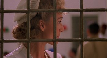 Movie still from “The English Patient” (1996), directed by Anthony Minghella – A person behind a fence; Close Up shot, Over the shoulder angle