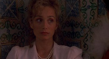 Movie still from “The English Patient” (1996), directed by Anthony Minghella – A person wearing a necklace; Close Up shot, Over the shoulder angle